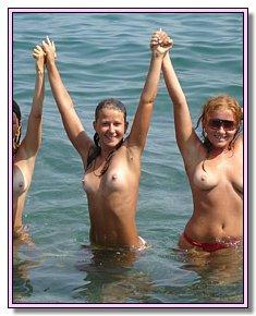 cheerful juvenile nudist girls takes off  their panties at European beach