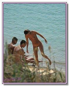 liberated nudist girls warms up their bottoms on the private beach