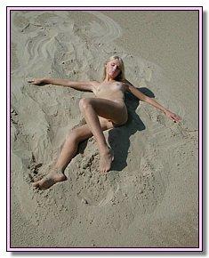 lovely nudists warms naked vagina in the sun on a nudist beach
