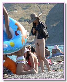 weary heat nudists-teenagers sunbathes without bikini on the beaches of Crimea