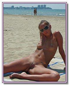 tanned nudist babes sunbathes without panties on the beach in Kazantip