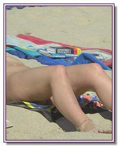 dissolute female nude chicks lie sunbathing naked in the beach of nudists