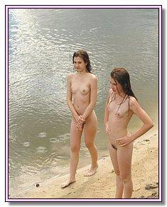 cute female naturists teases men on a sandy beach