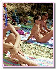 shapely nudists-teenagers lie in the sun In the company of nudists on the beach