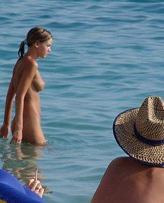 relaxed female naturists admires itself in the beach of nudists