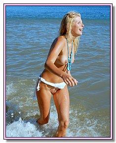 lovely nudist babes disclaims swimwear in the beach of nudists